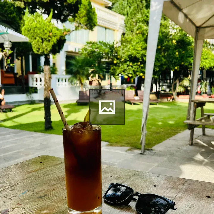 Iced drink with sunglasses on table