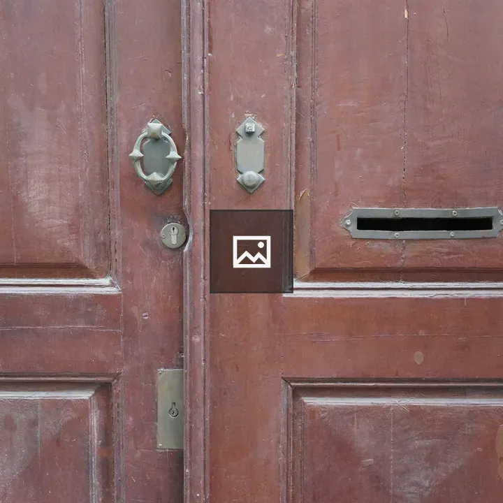 Old wooden door with brass accents