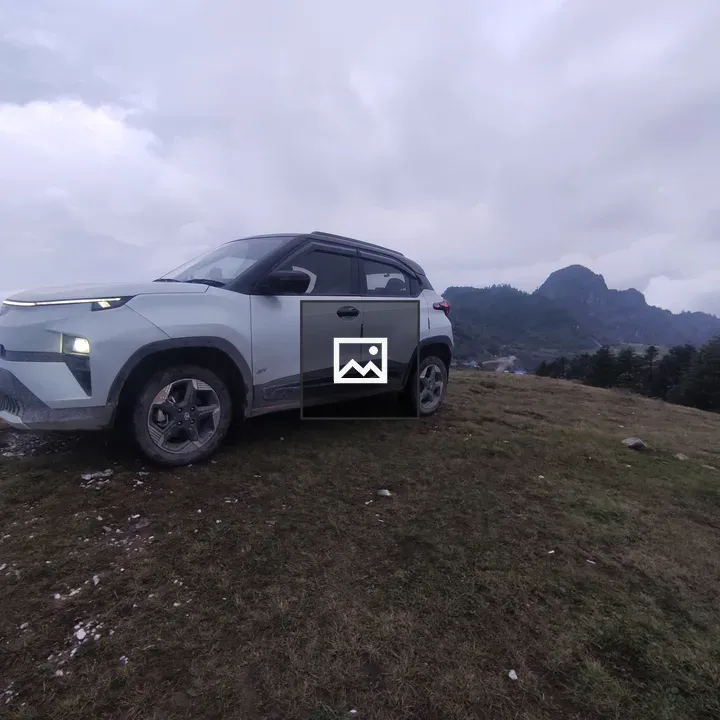 Silver SUV on grassy hilltop