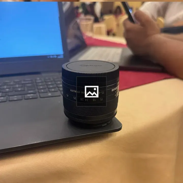 Camera lens on laptop tabletop