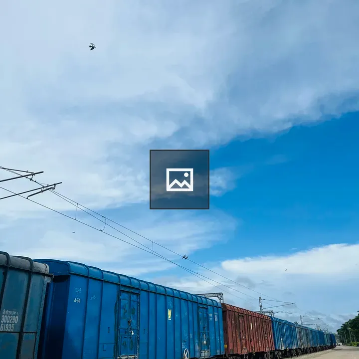 Train cars on track with blue sky