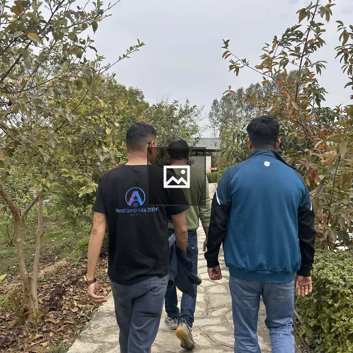 Three People Walking on Stone Path