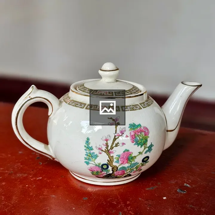 Elegant vintage teapot on wooden table
