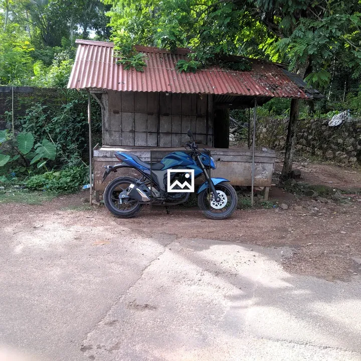 Blue motorcycle in a small shed setting