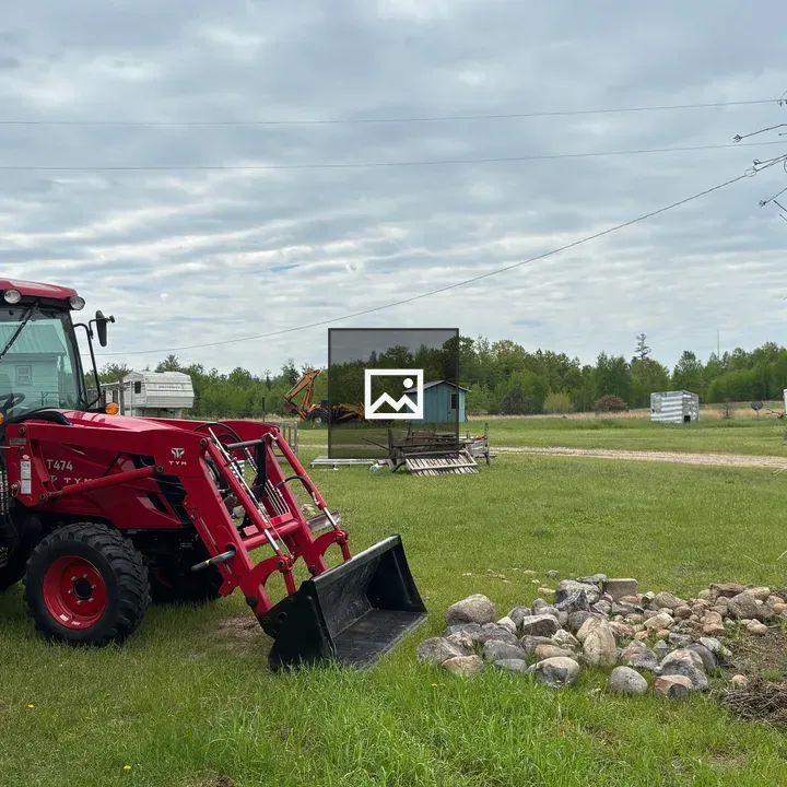 Large red tractor in farmyard