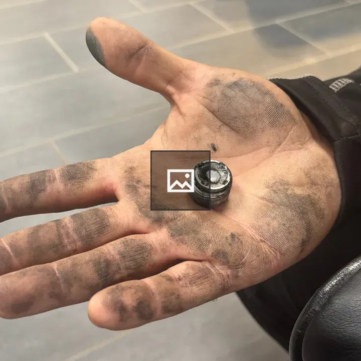 Dirty hand with metal plug in palm