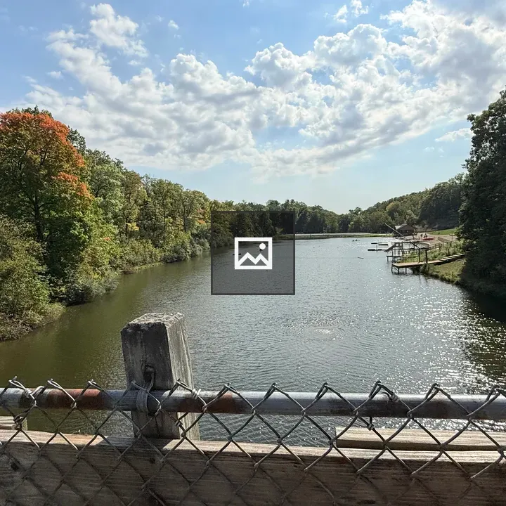 Bridge over lake with canoes