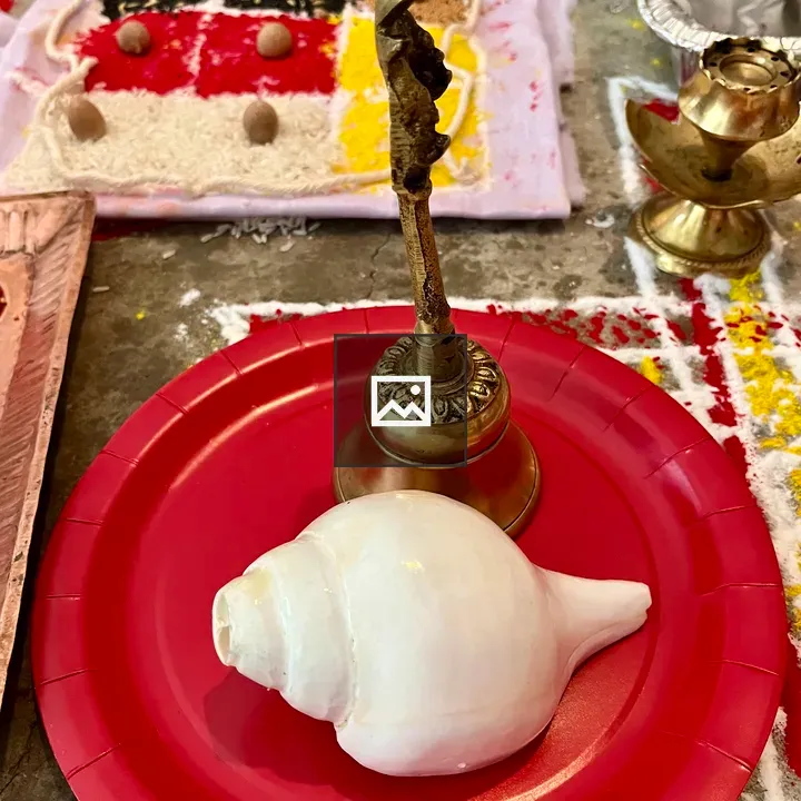 White conch shell with brass bell