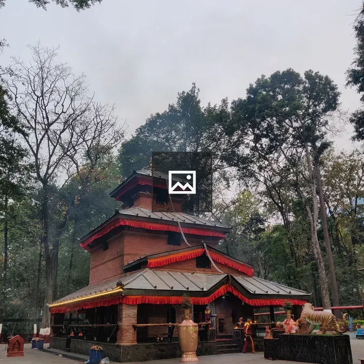 Temple with red trim in a forest
