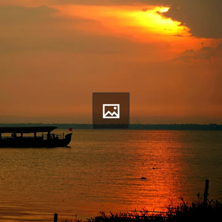 Silhouetted boat at sunset
