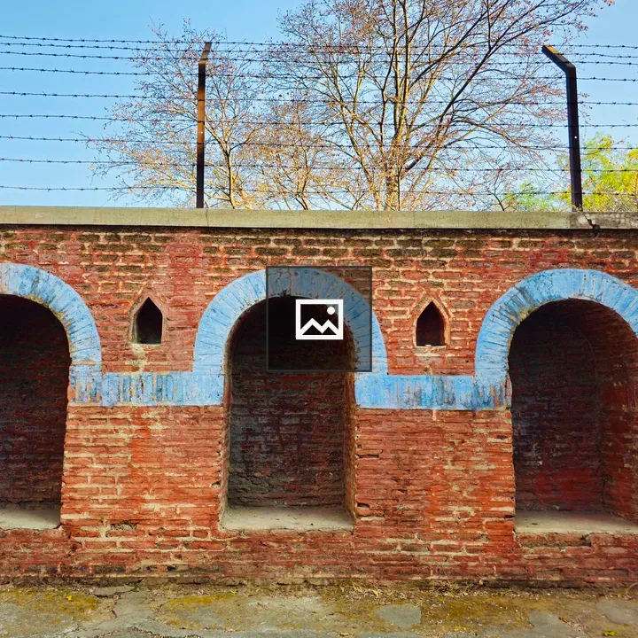 Brick wall arches with barbed wire
