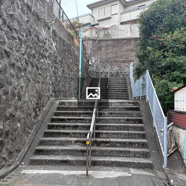 Concrete stairs between stone walls