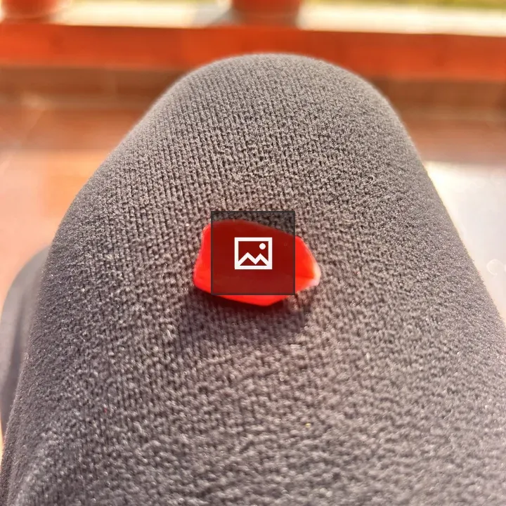 Red Petal on Knee