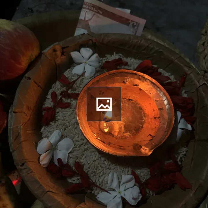 Clay diya in bowl of rice
