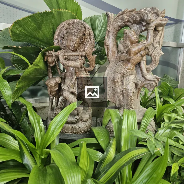 Two Wooden Sculptures with Greenery