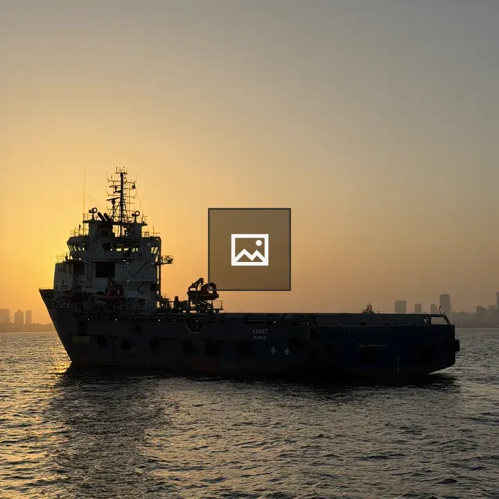 Tugboat silhouetted at sunset