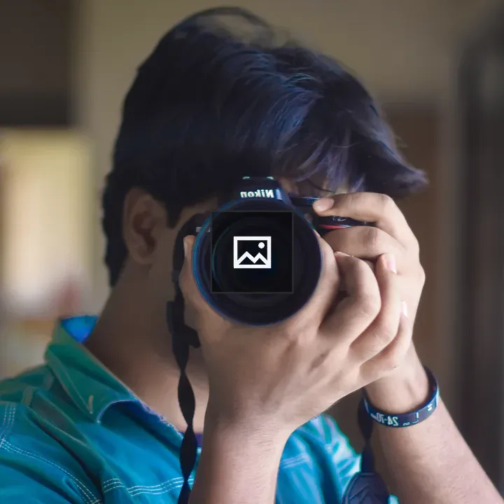 Person with camera facing viewer