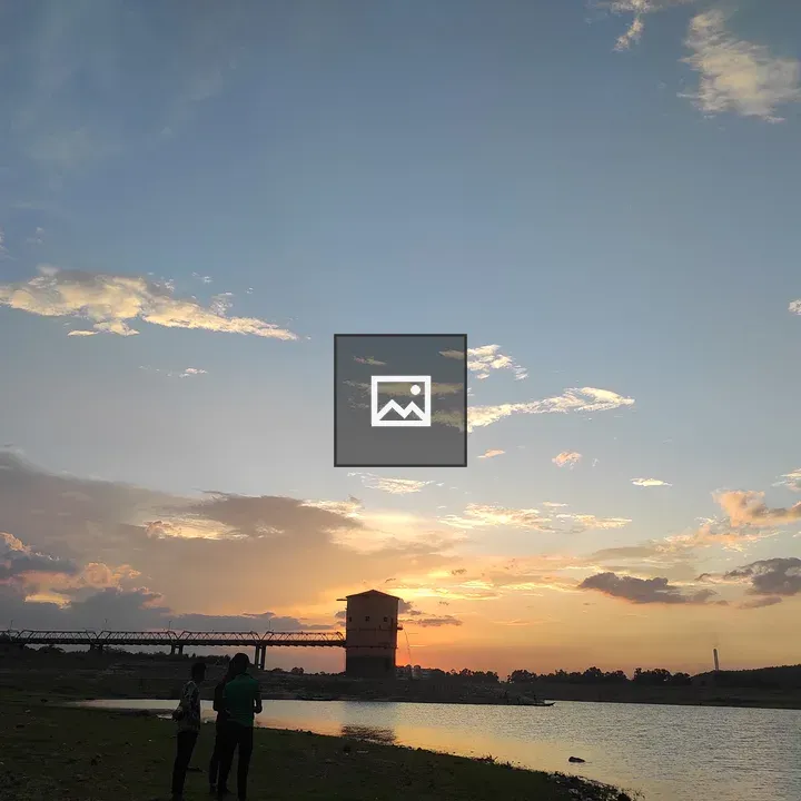 Sunset Over Water With Bridge