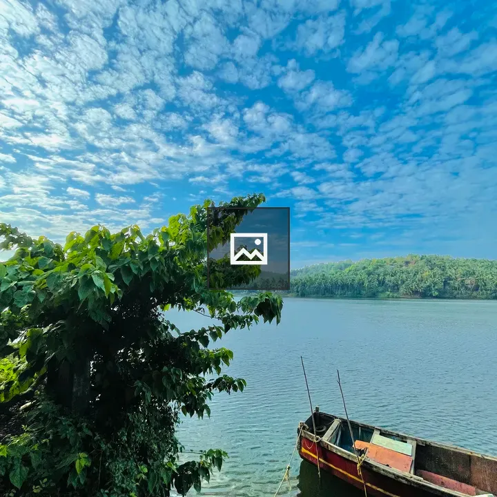 Clouds and boat by river