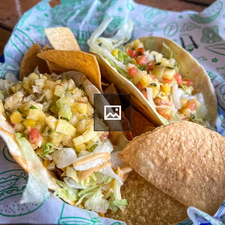 Tacos in a Basket on Wooden Table