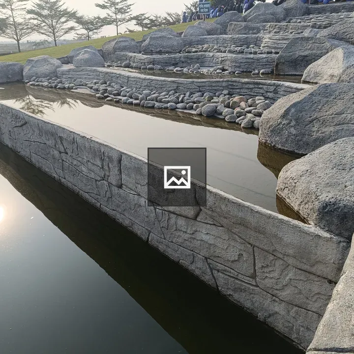 Artificial waterfall with stones in park