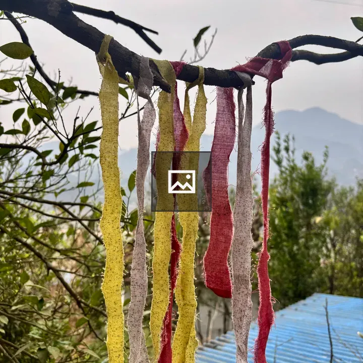 Colorful fabric strips on branch