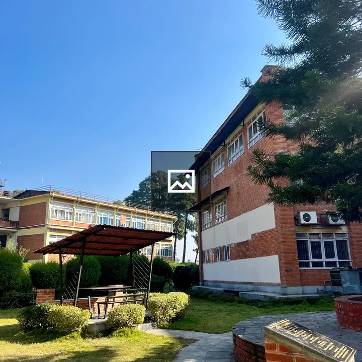 Landscaped Area with Red Brick Building