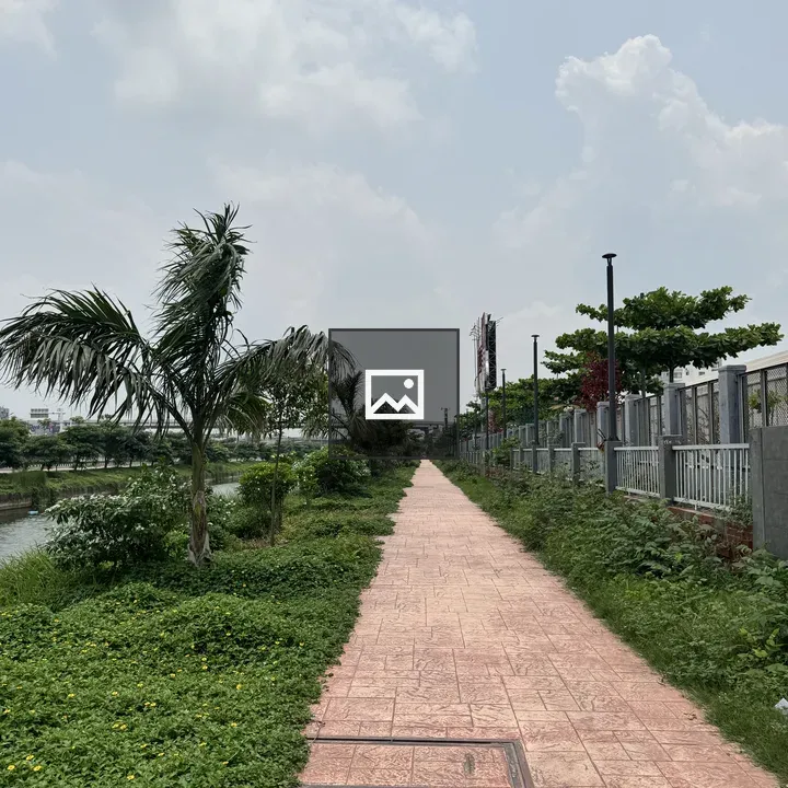 Path with pinkish paving along river