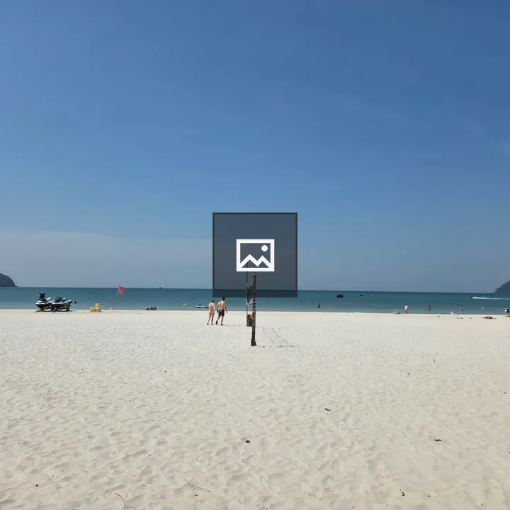 Beach scene with boats on horizon