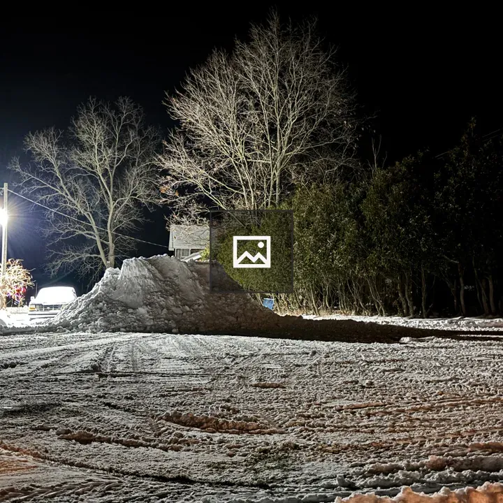 Snowy yard at night