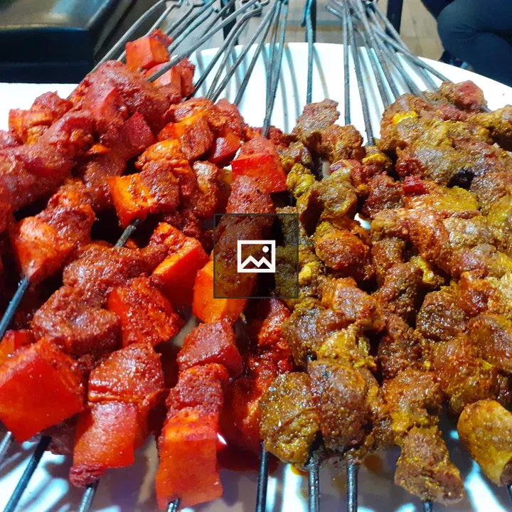Grilled pork meat skewers on table
