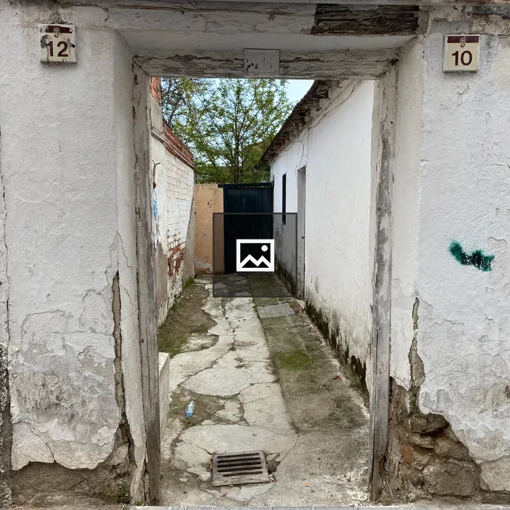 Narrow alley between white buildings