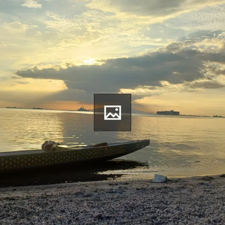 Boat on the shore at sunset