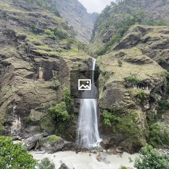 Tall waterfall in green mountains