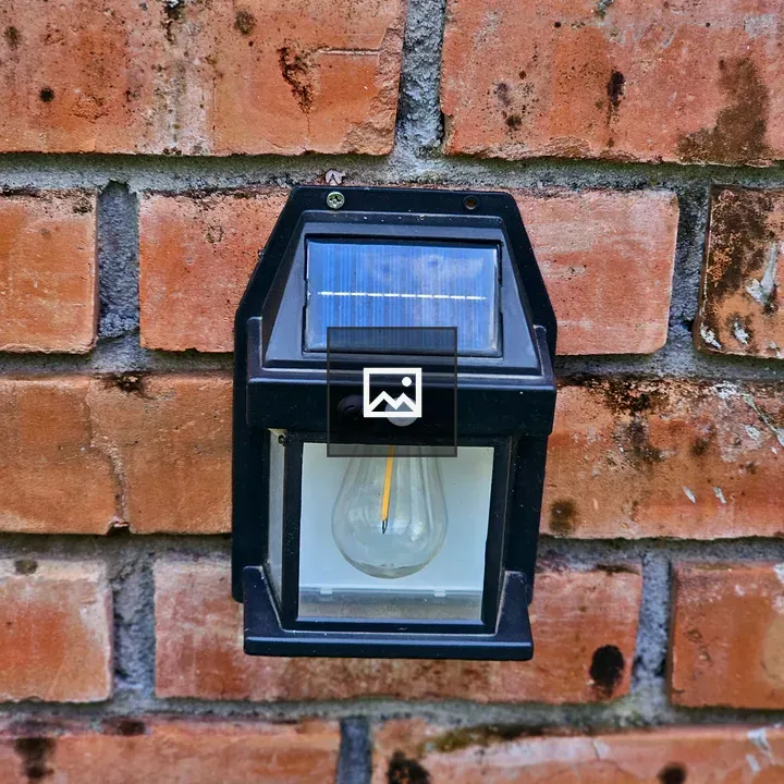 Solar-powered wall light on red brick wall
