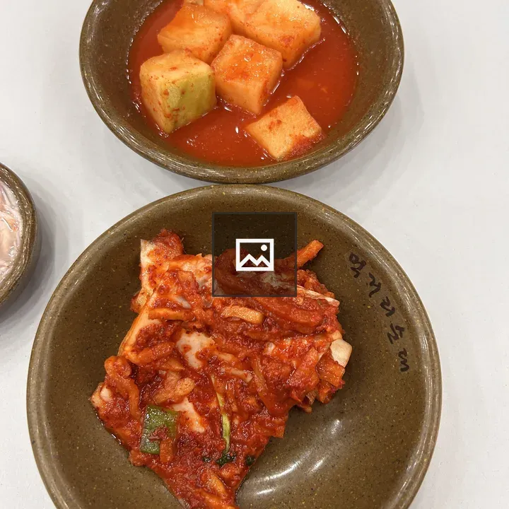 Two Ceramic Bowls with Pickled Melon and Kimchi