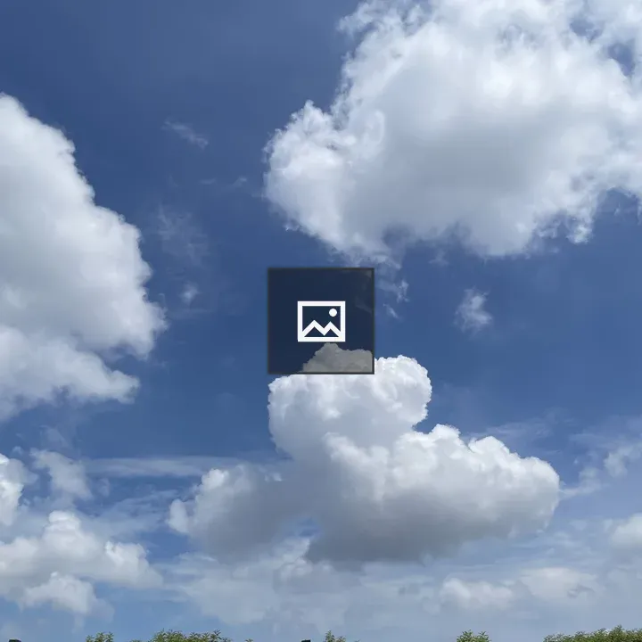 Cumulus clouds over green trees
