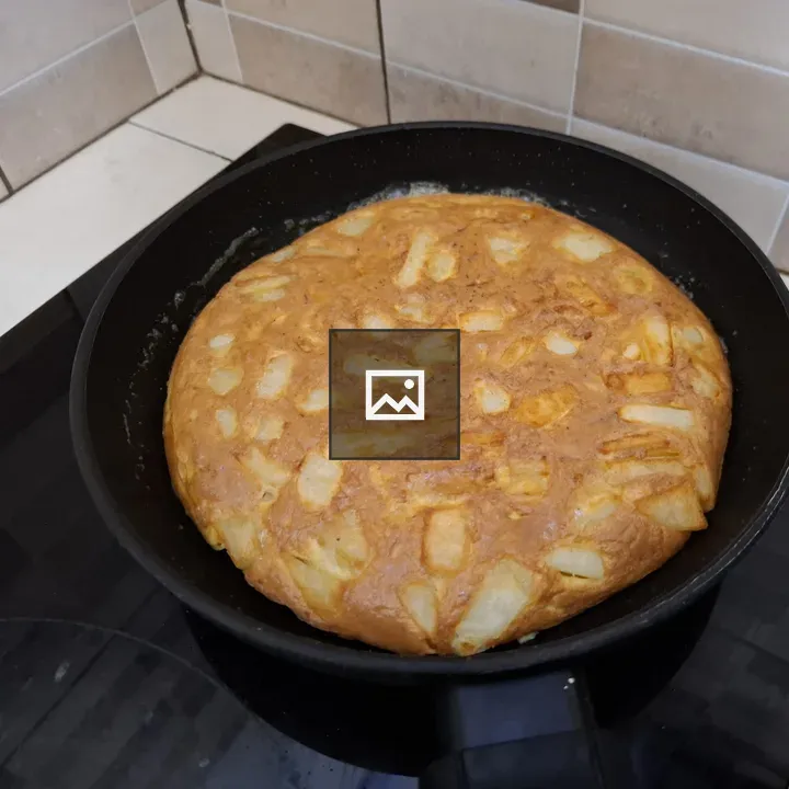 Golden tortilla-like dish in pan