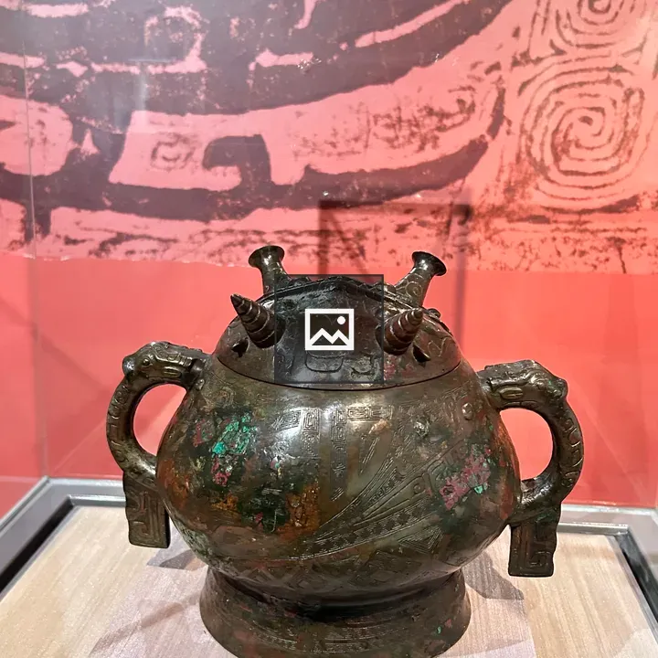 Bronze vessel with ornate handles