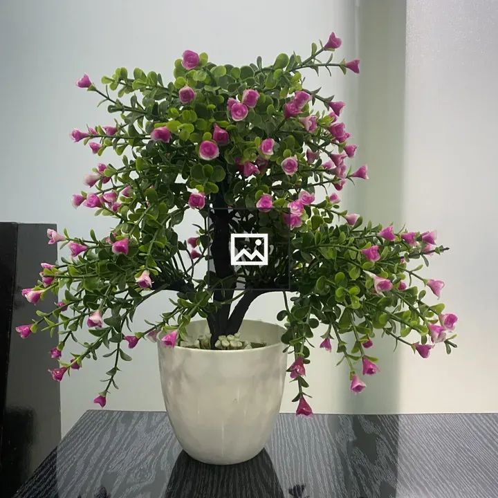 Small artificial tree in white pot