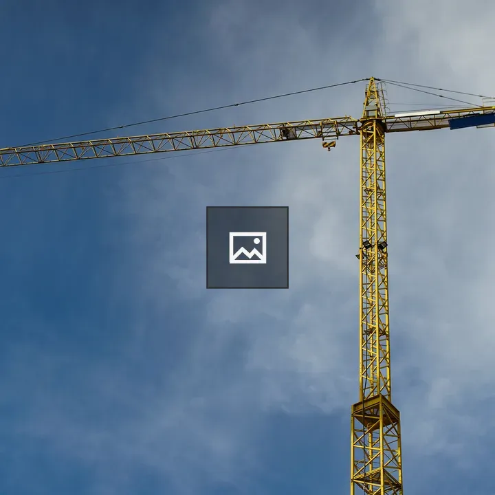 Big yellow crane against blue sky