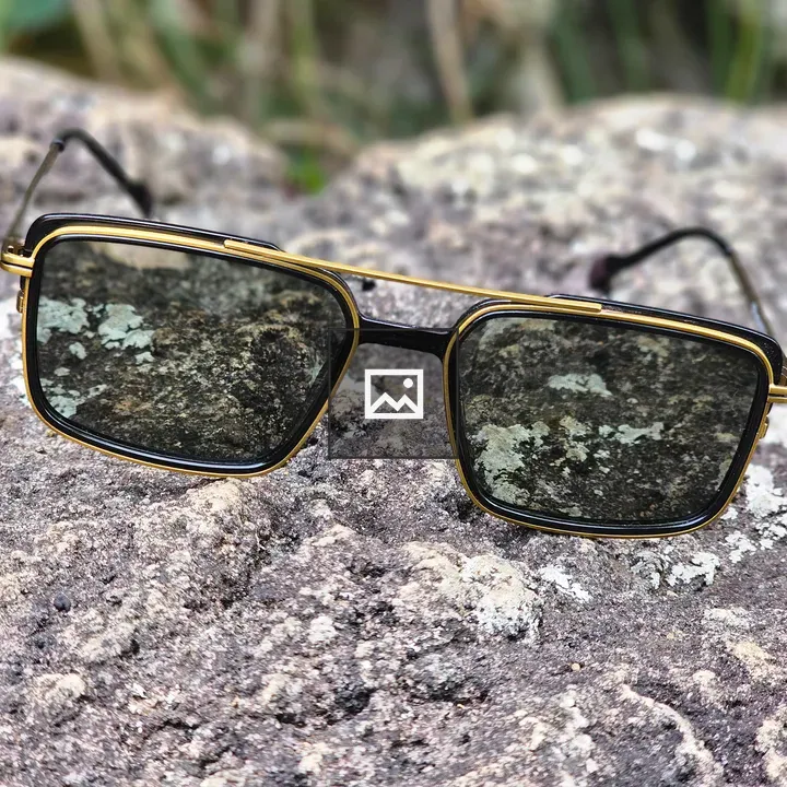 Eyeglasses on rock with blurred plants