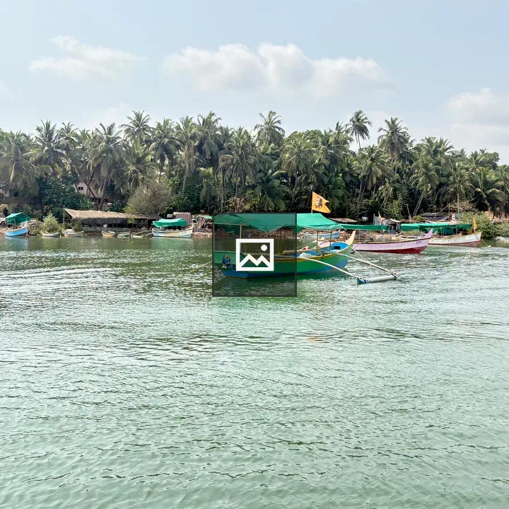 Green boat with yellow flag