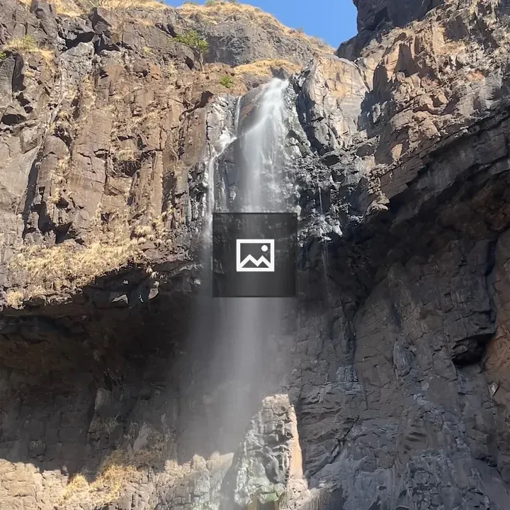 Waterfall on rocky cliff