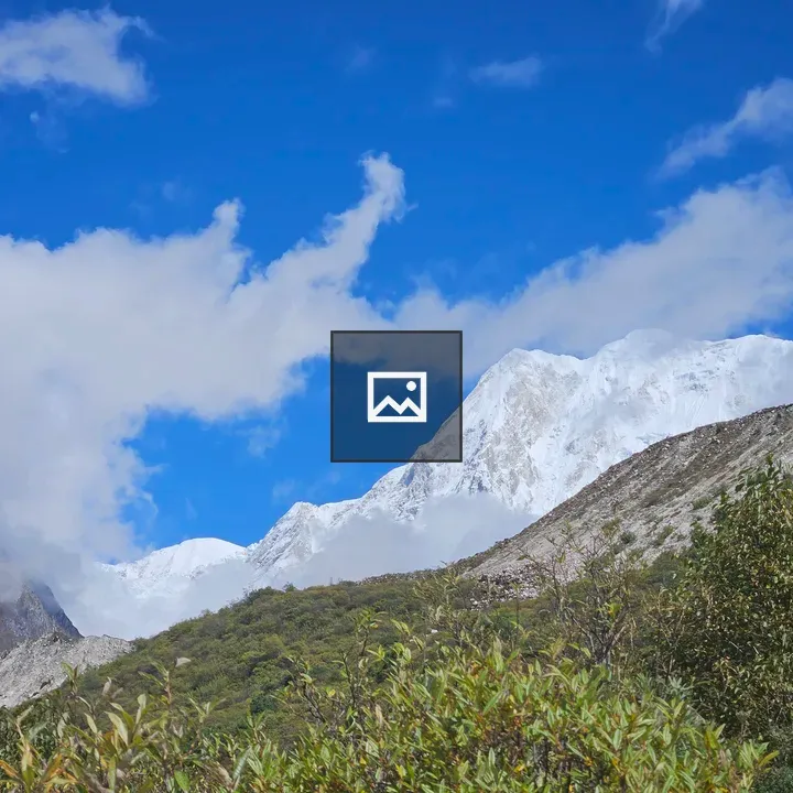 Snowy mountain peak against blue sky