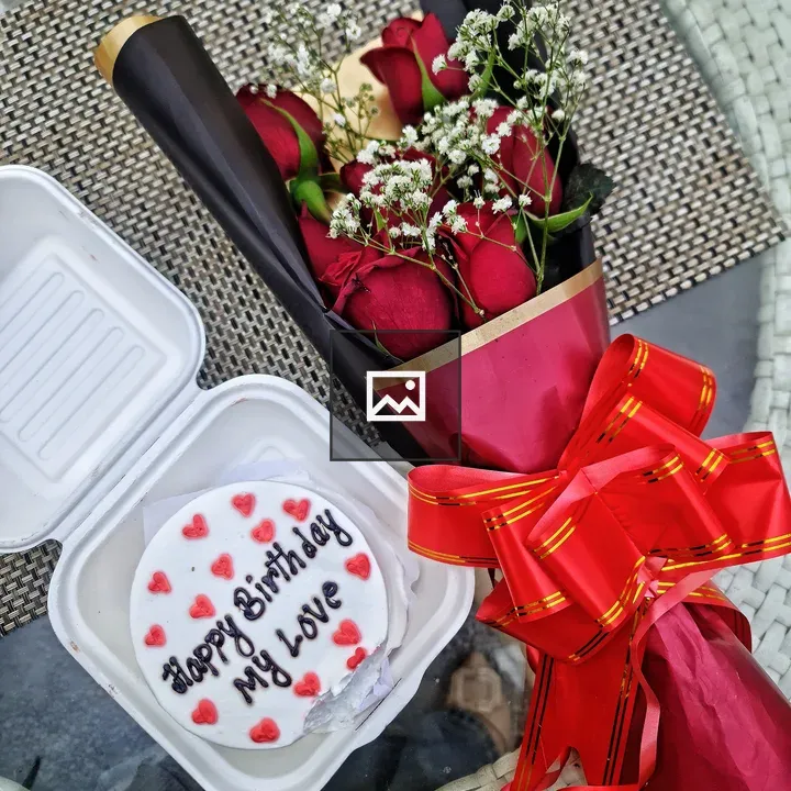 Birthday cake and red roses bouquet