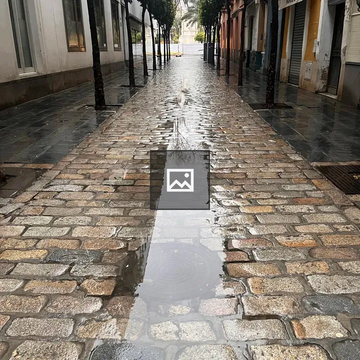 Street with puddles on rainy day