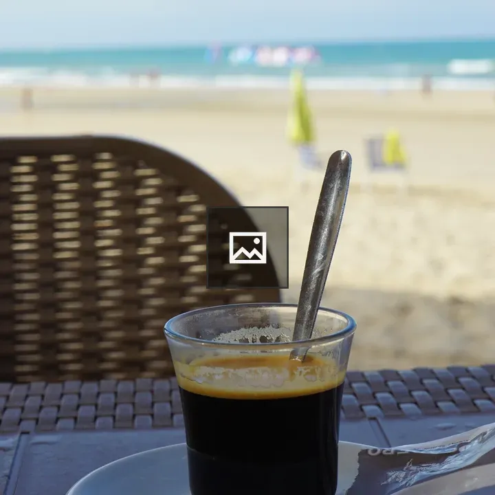 Cup of espresso on wicker table