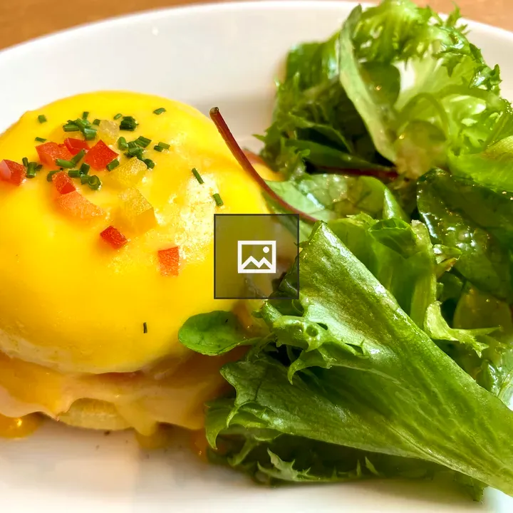 Eggs Benedict on Plate with Salad
