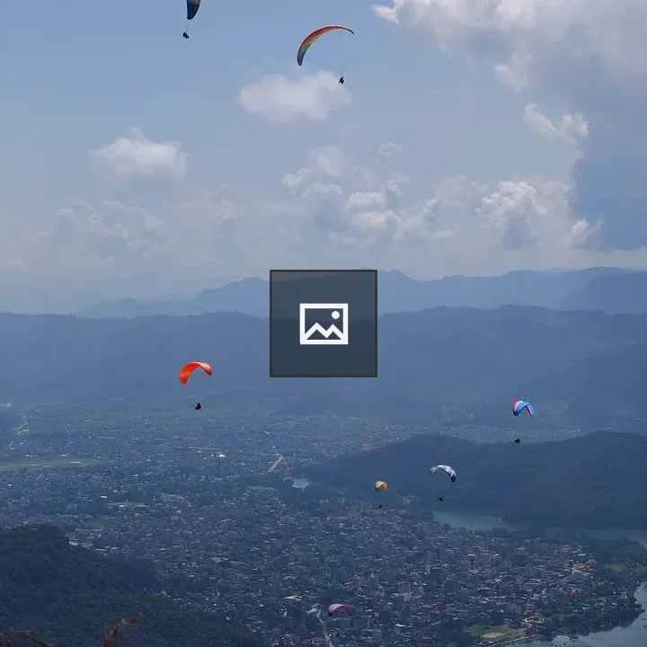 Paragliders Over Mountain Lake